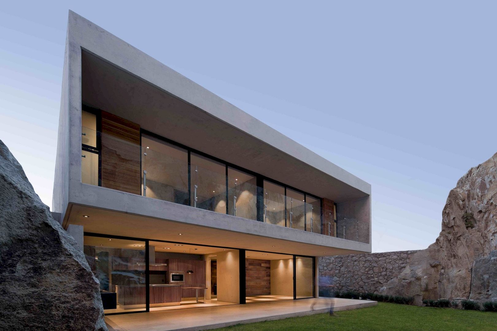 House of Stone: A Three-Level House with A 15-Meter-High Stone Wall